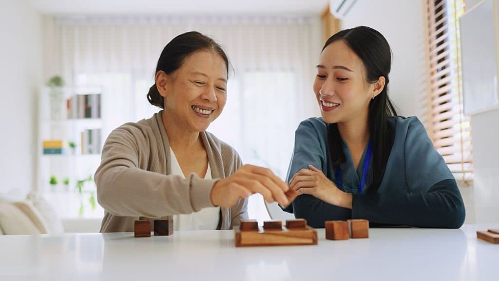 A nurse and an older patient working through a tabletop exercise together