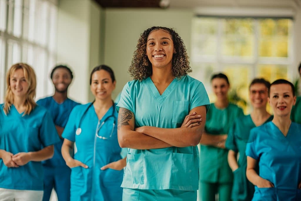 A team of nurses in scrubs standing together